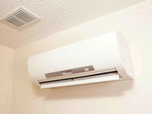 A wall-mount mini-split heating and air conditioning unit installed in a new house.